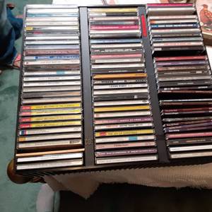 lot 329 image: Plastic Wall Mountable CD Organizer with Cds 