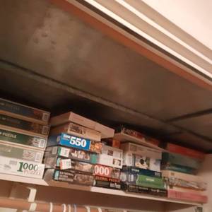 lot 344 image: All the Puzzles on a Shelf 
