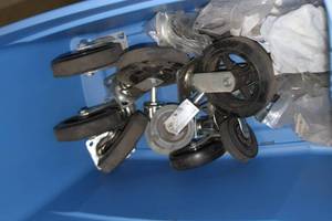 lot 26 image: Large Plastic Tote of Heavy Duty Casters