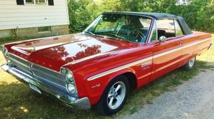 lot 1 image: WOWOW THE MUSCLE CAR OF YOUR DREAMS 1965 PLYMOUTH REALLY BLAZING RED HOT SPORT FURY CONVERTIBLE - WHAT DRAG RACES, DRIVE-INS & MAKEOUT SESSIONS WERE MADE FOR LOOKING FOR A NEW PLAYMATE TO KEEP ITS ENGINE ROARING Mileage 37,900