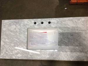 lot 30 image: Home Decorators Sonoma 48 in. W x 22 in. D Bath Vanity in Almond Latte with Marble Vanity Top in Carrara with White Basin damaged bottomLegs see pictures