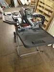 lot 22 image: RIGID 15 Amp 10 in. Tile saw with Stand used in working condition open Box see pictures