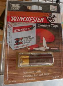lot 54 image: Winchester knife shaped like a shotgun shell, rosewood handle