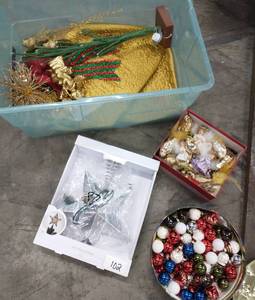 lot 102 image: Tote of christmas dcor, small bulbs, angels and birds, tree topper, and tree skirt
