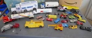 lot 133 image: Lot of toy vehicles, includes a vintage tin Holiday Station semi and an old Auburn plastic truck, a Matchbox dumper truck, a Taylor crane, a Tonka semi and Tonka wrecker