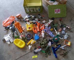 lot 134 image: GI Joe locker full of various male doll clothes and accessories for GI Joe and Ken.  Diving, parachuting, astronaut suits, boats, shoes, scuba tow, all kinds of fun adventures