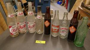 lot 176 image: 9 vintage pop bottles, Pepsi 12 and 10oz, Orange Crush, Hires 8oz, Coke 10oz