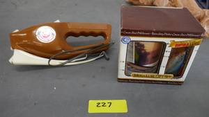 lot 227 image: Actual Ron Popeil Pocket Fisherman in very good condition, works fine, and a Rapala lure and mug
