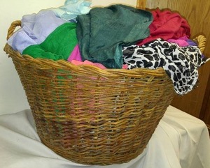 lot 93 image: Yards of Material in Large Wicker Basket.