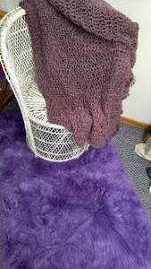 lot 97 image: Purple Accent Rug, throw and White Wicker Chair.