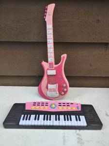 lot 36 image: Two Toy Instruments Including Barbie Guitar