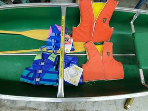 lot 7 image: Canoe with life jackets and 2 wood oars
