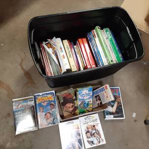 lot 172 image: a collection of VHS movies, DVDS of TV series Bonanza and Andy Griffith as well as a bunch of books ranging from animals to guides to Websters dictionary.