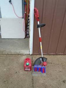 lot 29 image: Craftsman 110 volt weed trimmer. Lightly used. Tested & works. Includes 1 gal gas can. As shown.