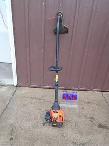 lot 30 image: Remington 2 cycle weed trimmer. Used condition. Tested & works. As shown.