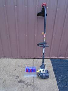 lot 31 image: Ryobi 2 cycle weed trimmer. Used condition. Tested & works. As shown.