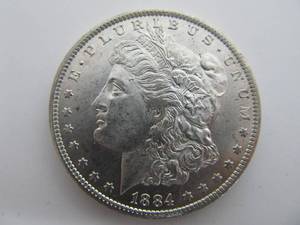 lot 242 image: 1884 O Uncirculated Morgan Silver Dollar Au