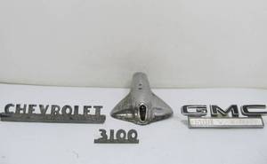 lot 277 image: Vintage Chevy & GMC Metal Auto Emblems & Chrome Peters & Russell Exhaust Tip
