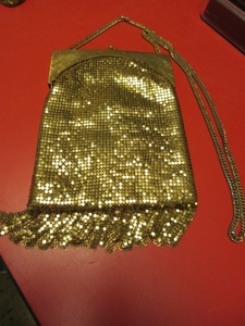 lot 813 image: WHITING & DAVIS GOLD MESH BAG WITH FRINGE BOTTOM AND SHOULDER STRAP