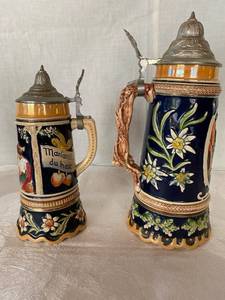 2 German beer stein with Swiss music box with pewter lids.