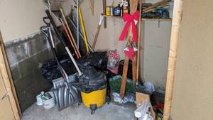 lot 352 image: Closet of Yard Items - Rakes, Shovels, Shop-Vac, YardPest Sprays, Vintage Decorative Skis, and more
