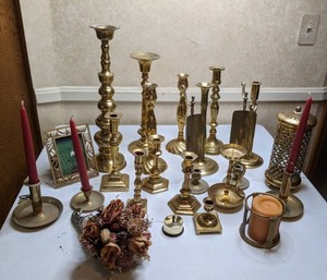 lot 107 image: Lot of (23) Brass Candleholders, Picture Frame, & More