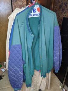 lot 122 image: Hanging Rolling Clothes Rack with Fur Cape, Trench Coats, Athletic Jackets
