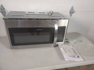 lot 9 image: New Frigidaire Over the Stove Microwave - Shipping Damage, Needs Repair