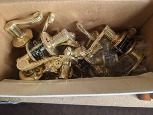 lot 52 image: Lot of Lever Style Doorknobs Orion & Other Brass Doorknobs