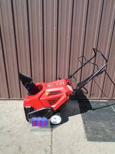 lot 1 image: Troy Bilt 4 cycle snow thrower. New condition. Has a few cracks in plastic from shipping damage. Tested & works. As shown.