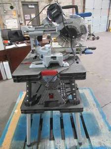 lot 48 image: Kobalt 12-in Compact Dual Bevel Sliding Miter Saw With Stand. SM3017LW - Works, maybe missing parts - cracked baffold.