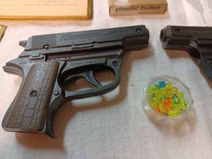 lot 221 image: Pair of Sekiden Automatic SAP .50 Plastic Pellet Guns with 6mm Pellets and Vintage Paper Targets