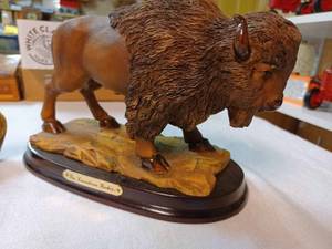 lot 224 image: Three Bison One a Large Souvenir Bison of The Candian Rockies, Bison Wall Plaque and an Onyx Bison