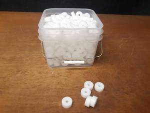 lot 394 image: Bucket full of Nylon Bushings - Dimensions are 1-38 OD x 38 ID x 916 Tall