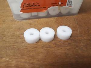 lot 406 image: Bucket Half-full of Nylon Bushings - Dimensions are 1-38 OD x 38 ID x 916 Tall