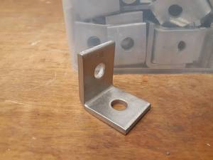 lot 396 image: Bucket Lot of 316 Stainless 90° Brackets - Measures 1-12 Wide x 2 Tall on each side. Hole is 916