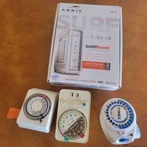 lot 17 image: Arris Surfboard Cable Modem and Three Appliance Timers