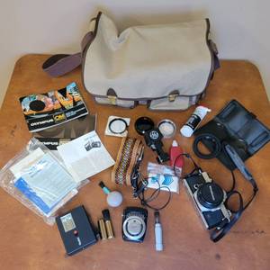 lot 31 image: Vintage Olympus OM-1 Camera wStrap. Original Manuals, Accessories and Bag