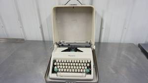 lot 47 image: Antique Deluxe Olympia Typewriter In Carrying Case