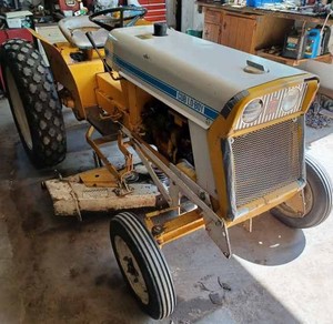 lot 1 image: International Cub Lo-Boy with 3-point, 48 inch Mower Deck, Snow Blower, Cab and Tire Chains