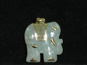 lot 35 image: Carved Jade Elephant Pendant with 14 Karat Yellow Gold Accents