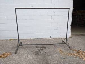 lot 132 image: Rolling Steel Hanging Rack - Missing 1 Wheel - Measures about 7 x 67 - Made from 1 Steel Pipe - NO SHIPPING