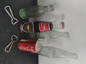 Collection of Vintage Coca-Cola Bottles and Bottle Openers
