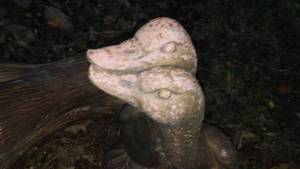lot 155 image: Yard dcor, Cement ducks and stump.  Loc on deck