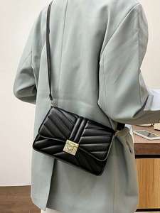 lot 34 image: Textured Twist Lock Crossbody Bag