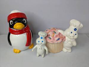 lot 438 image: Lot of (2) Adorable Cookie Jars - Penguin & Pillsbury Dough Boy w Cupcake