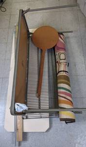 lot 601 image: Miscellaneous Household Lot - Rug, Ironing Board, Table, Curtain Rod, Pizza Peel, Piece of Wood Scrap