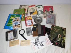 lot 469 image: Miscellaneous Reading Materials, Magnifying Glass Bookmark, Alcoa Aluminum Figure, and more