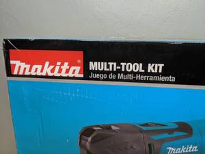 lot 14 image: New Makita 3 Amp Corded Variable Speed Oscillating Multi-Tool Kit With Blade, Sanding Pad, Sandpaper, Adapter, Hard Case