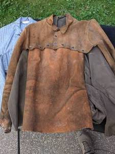 lot 79 image: The Shop Lot includes Leather Welding Coat, Rain Coat, Overalls, Tire Iron & Jack